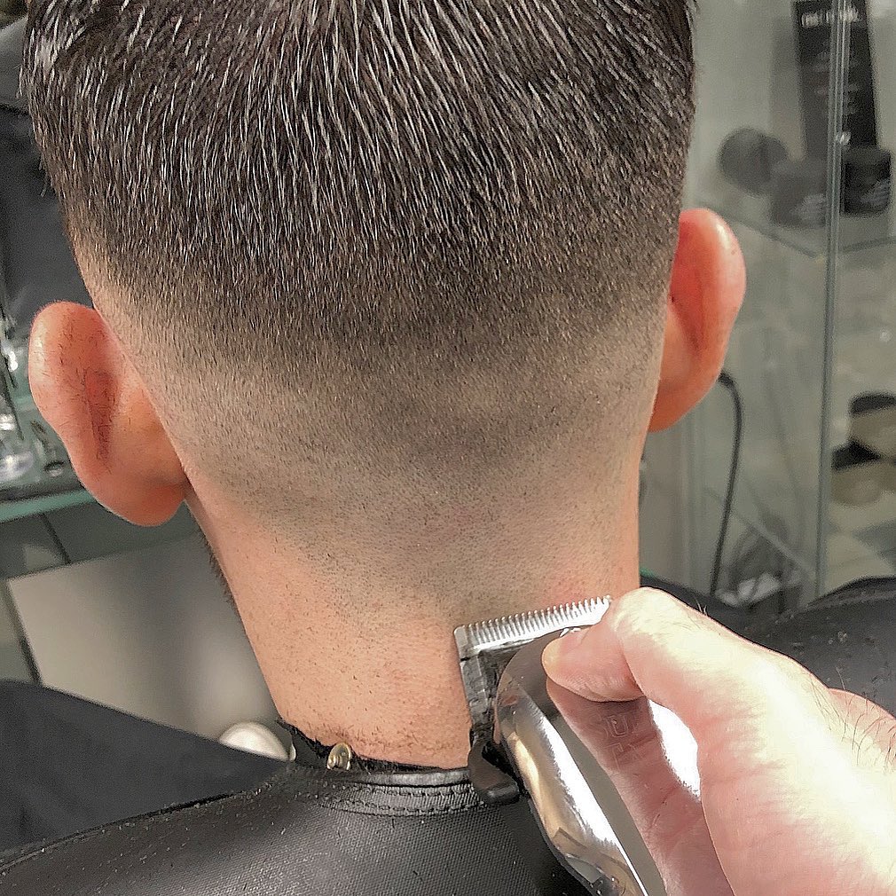 Careful clipper finishing at the back of a haircut